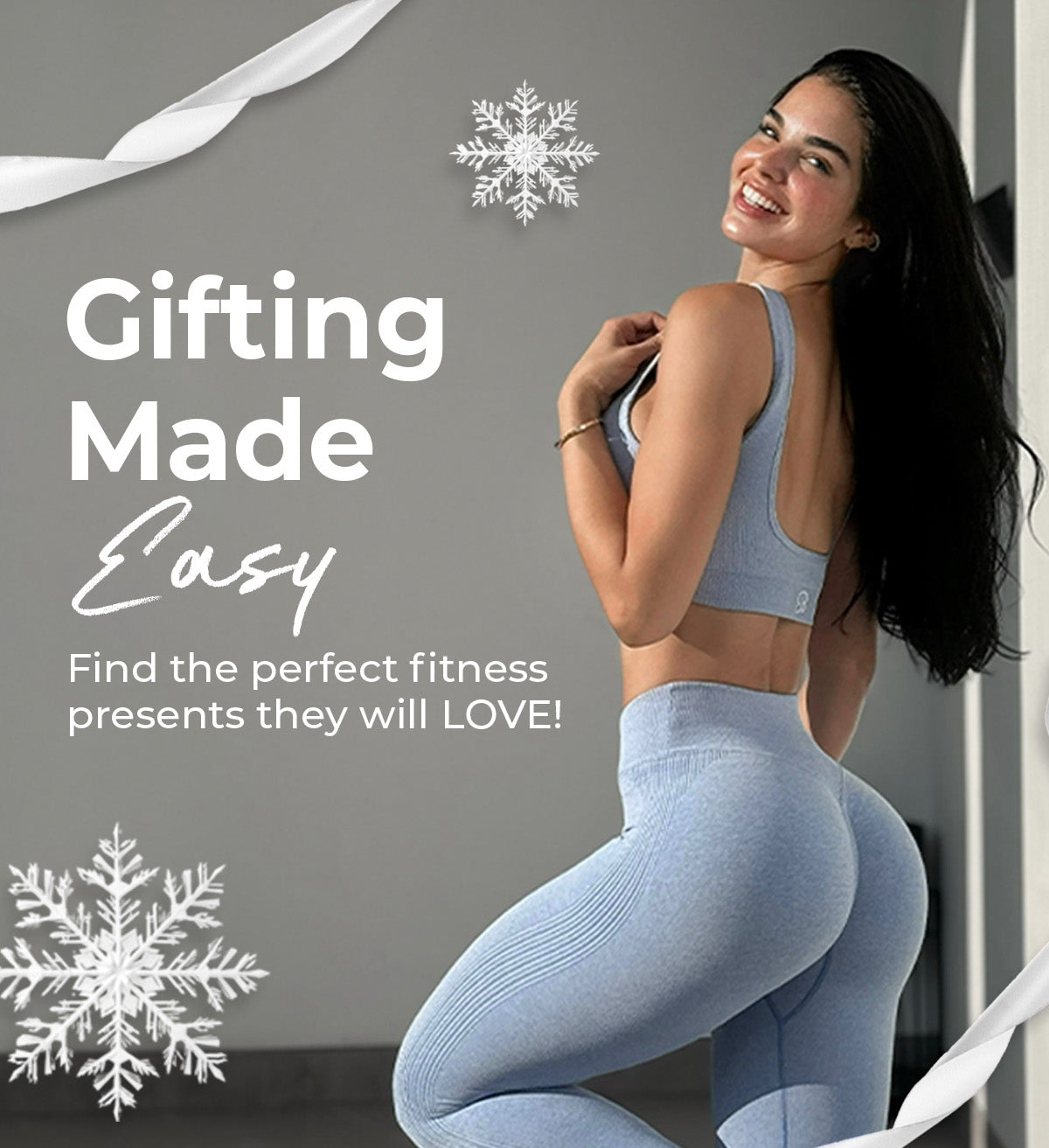 back left view of model wearing a light blue activewear set. White ribbon and snowflakes are on the image. Text reads "GIFTING MADE EASY. FINE THE PERFECT FITNESS PRESENTS THEY WILL LOVE"