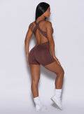 back profile picture of a model wearing our chocolate-colored laced bodysuit shorts 