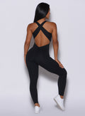 back profile picture of a model posing in our black laced bodysuit 