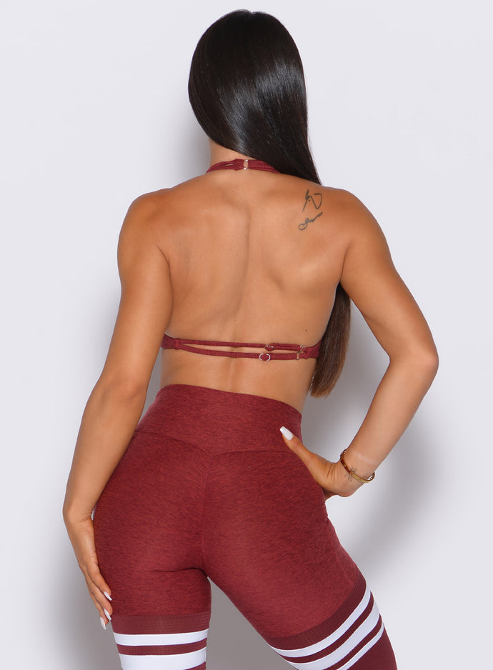 back profile view of our model with on hand on her waist wearing the Dragonfly Bra in Rouge color