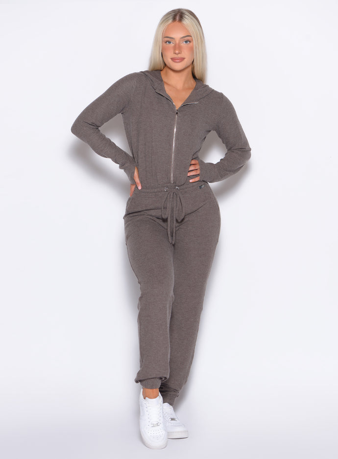 front profile view of a model wearing the Flirty Jumpsuit in Cozy chocolate color