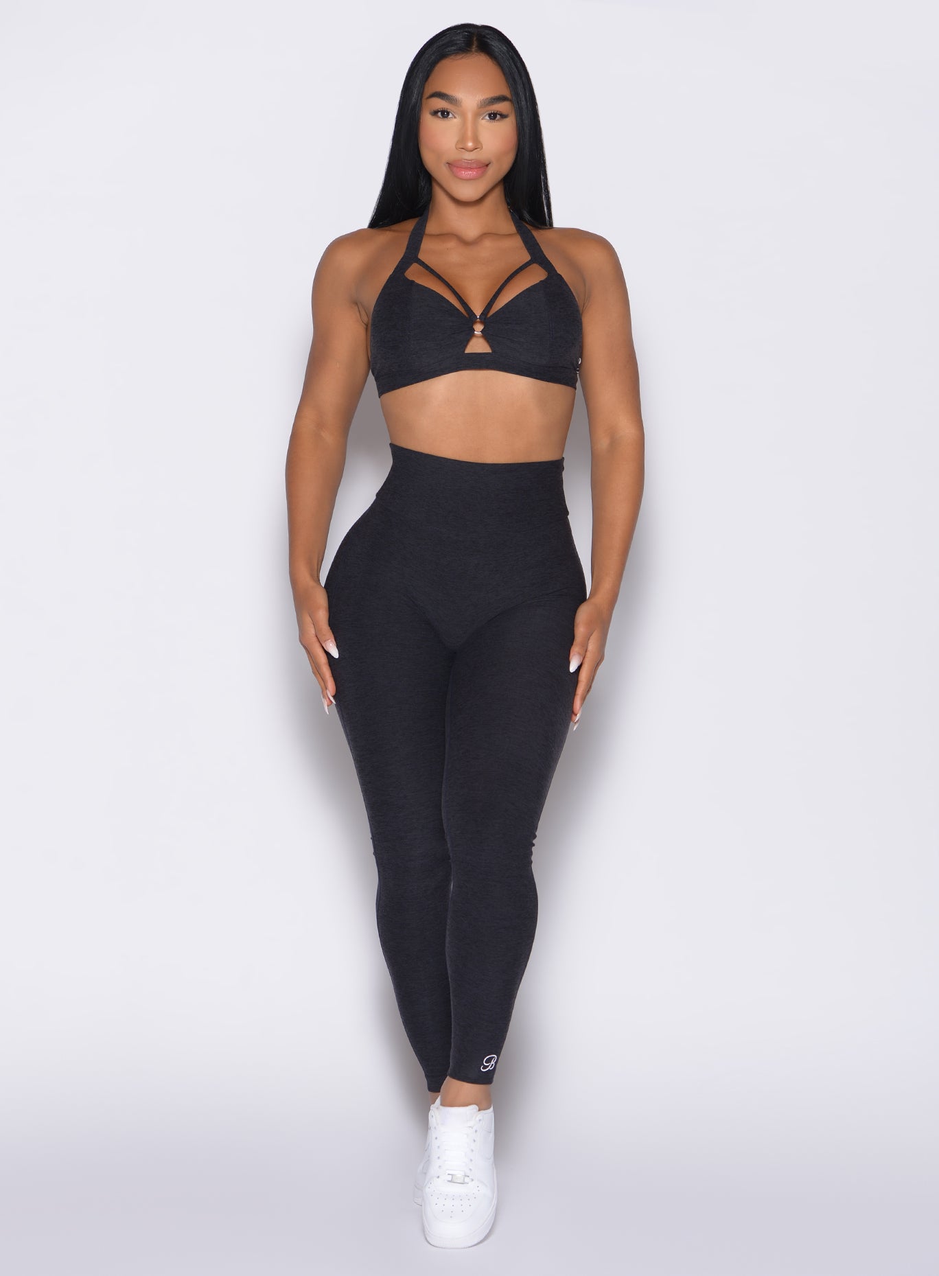 front profile view of a model wearing the Movement Leggings in Heathered Black color