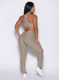 back right side profile view of a model wearing the V Butt Lift Leggings in Toasted Sugar color