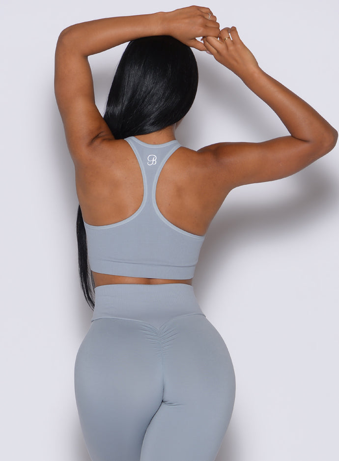 Back profile view of our model wearing the Lifter Seamless Bra in Carbon color