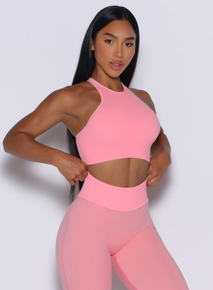 front profile picture of a model in our Lifter Seamless Bra and the matching leggings in Peach Burst color