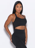 front profile picture of a model in our High Impact Bra in Black color and the matching leggings
