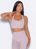 front profile view of a model wearing our High Impact Bra in Violet Ice color and the matching leggings