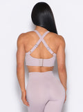 back profile of a model wearing the High Impact Bra in Violet Ice color and the matching leggings
