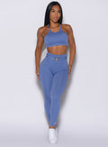 front  profile view of a model wearing our peach bottoms leggings in denim blue color along with the matching sports bra