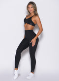 front left side profile view of a model wearing the Internal Scrunch Leggings in black color