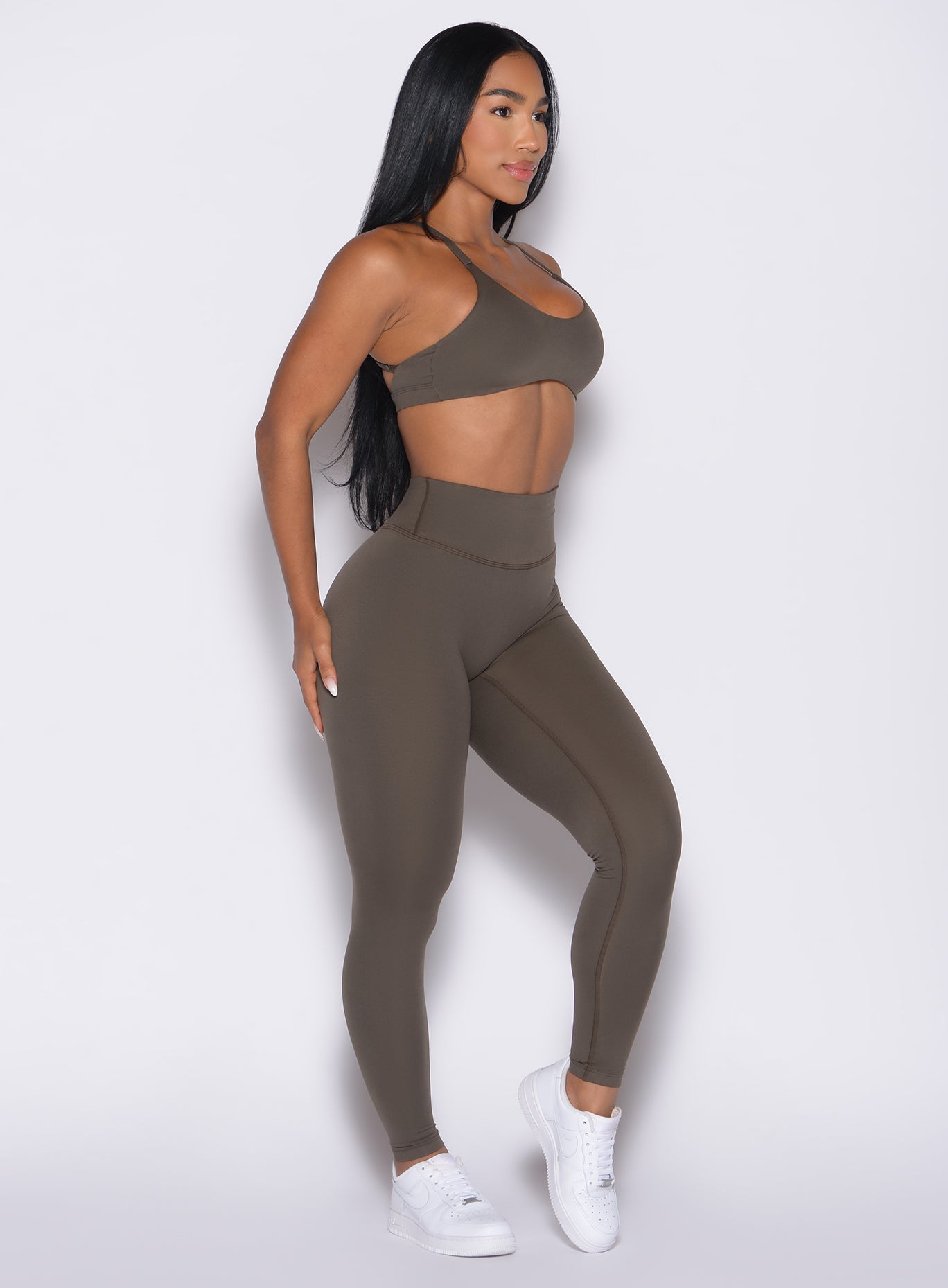 front right side profile view of a model wearing the Internal Scrunch Leggings in winter oak color paired with the matching bra