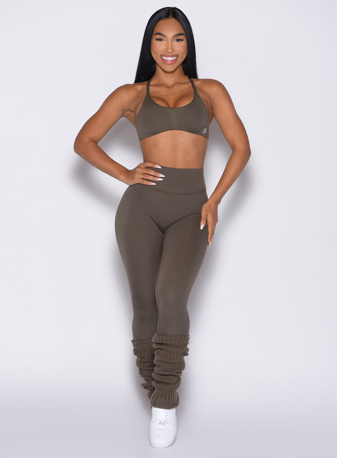 front profile view of a model wearing the Luxe Leg Warmers in Winter oak color paired with the matching leggings and bra 