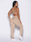 back right side profile view of a model wearing the Internal Scrunch Leggings in Glacial beige color