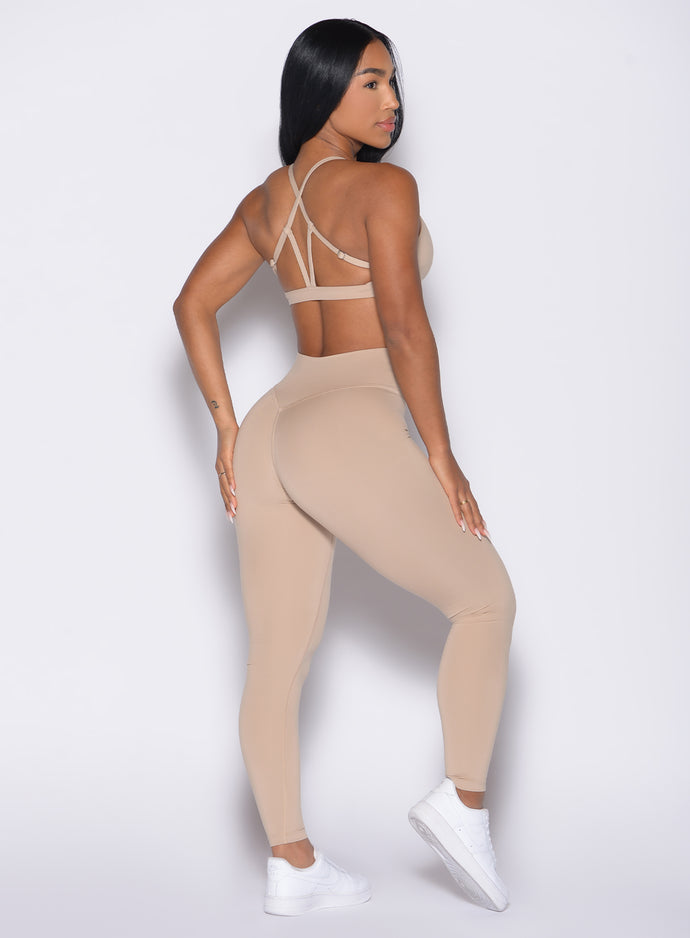 back right side profile view of a model wearing the Internal Scrunch Leggings in Glacial beige color