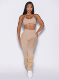 front profile view of a model wearing the Internal Scrunch Leggings in Glacial beige color