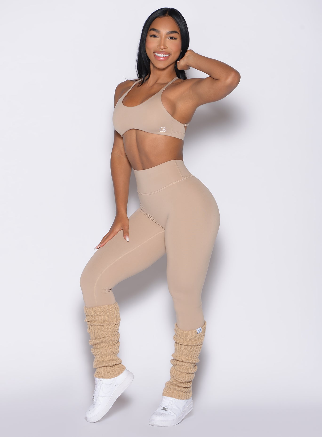 front left side profile view of a model wearing the Internal Scrunch Leggings in Glacial beige color