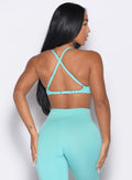 back profile view of a model looking to the right side wearing the Kini Bra in aquatic awe color