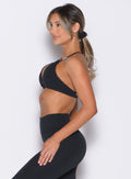 left side profile view of a model wearing the Kini Bra in black color