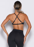 back profile view of a model wearing the Kini Bra in black color