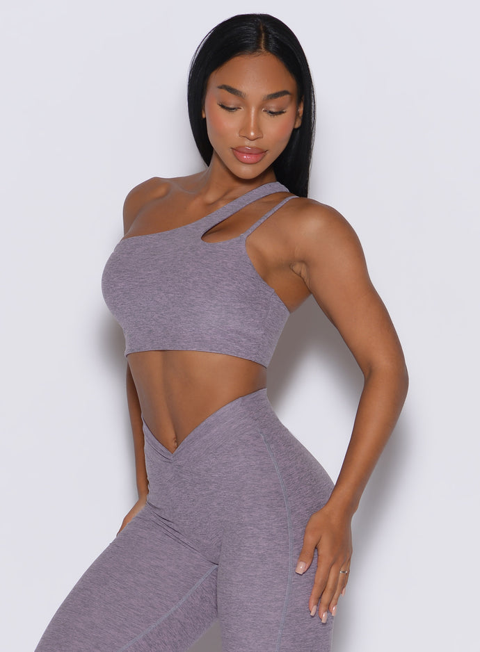 front profile view of a model wearing our lateral top in Lilac Grey along with a matching leggings 