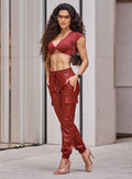 Model in outdoors wearing the Liquid Cargos in Brick red color paired with the matching top