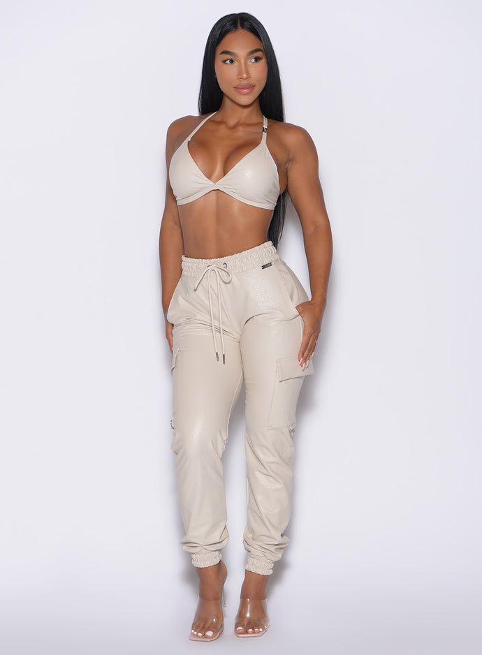 front profile view of our model looking to the left side wearing the Liquid Cargos in champagne color paired with the matching bra