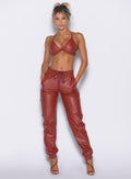 front profile view of our model with both hands inside the pocket of the Liquid Cargos in brick red color