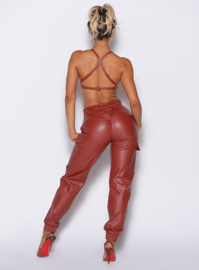 back profile view of our model wearing the Liquid Cargos in brick red color