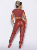 back profile view of our model facing to the right side wearing the Liquid Cargos in brick red color