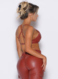 right side profile view of our model wearing the Liquid Kini Bra in brick red color