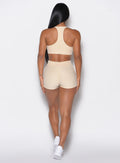 Back profile view of our model wearing the Cloud Comfort Shorts in vanilla color