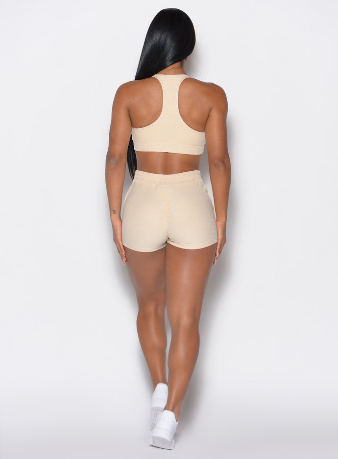 Back profile view of our model wearing the Cloud Comfort Shorts in vanilla color