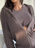 close up front profile view of a model in indoors wearing the Gym Crush Hoodie in Cozy chocolate color