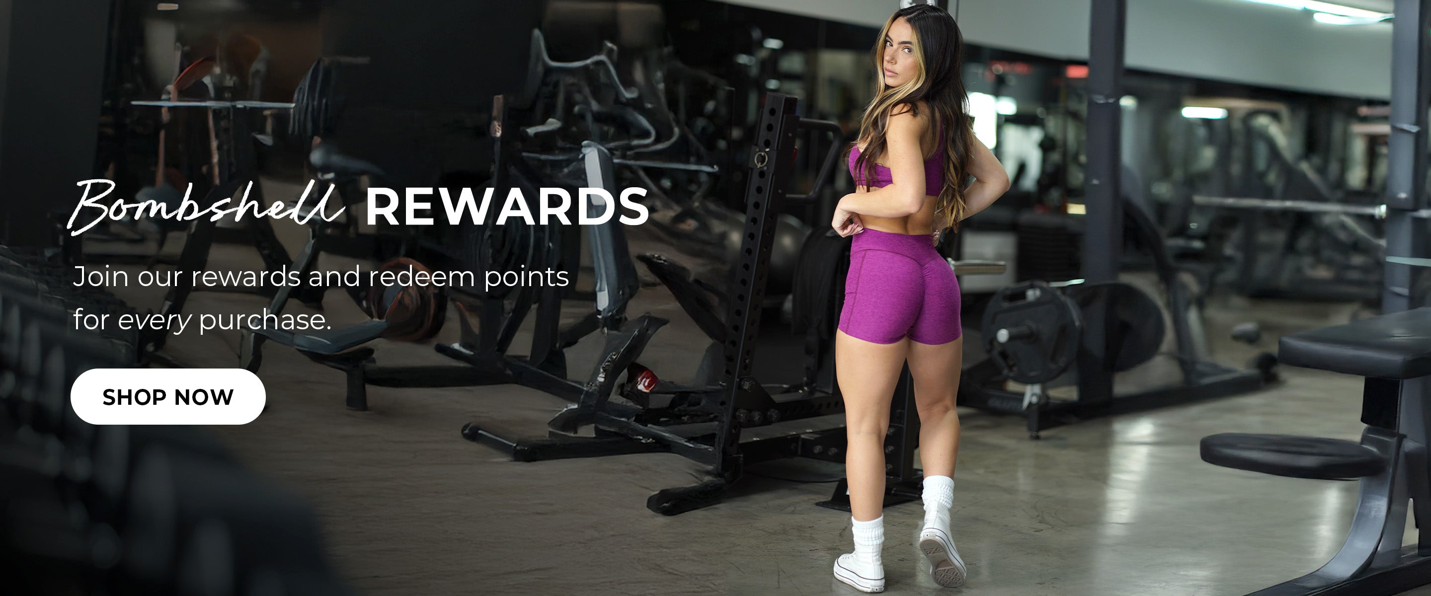 back image of model in gym wearing fuschia purple short set. Text overlay reads "bombshell rewards Join our rewards and redeem points for every purchase" SHOP NOW