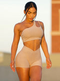 front profile view of a model in outdoor wearing our Lateral Top and the matching shorts in Desert Taupe color