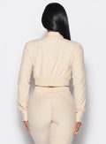 back profile view of our model wearing the Cloud Crop Jacket in vanilla color