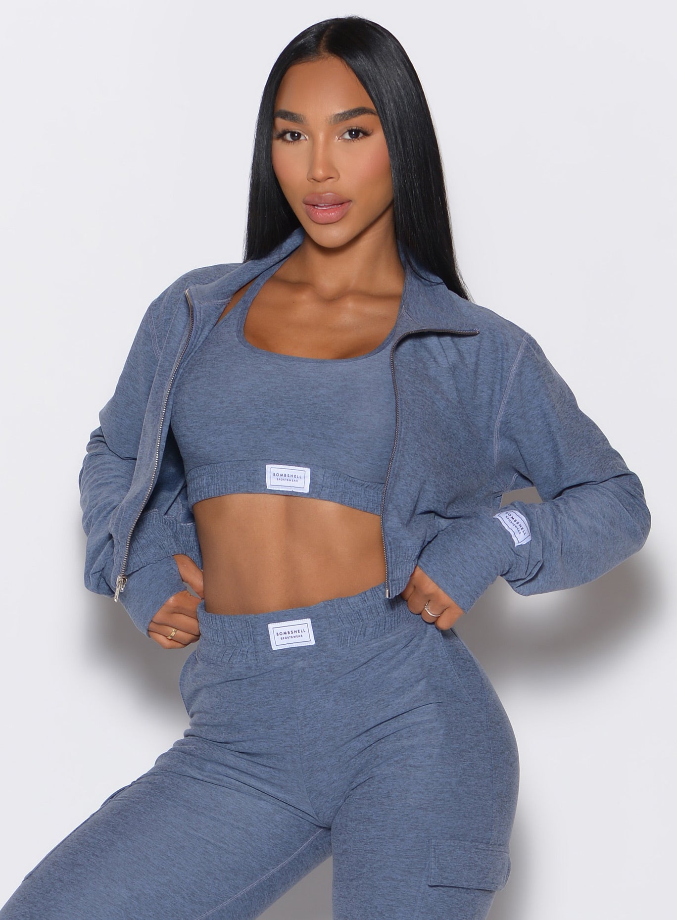 Front profile view of our model wearing the Cloud Crop Jacket in twilight color with the matching sports bra