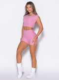 front left side profile view of a model wearing the Movement Shorts in Candy Pink color