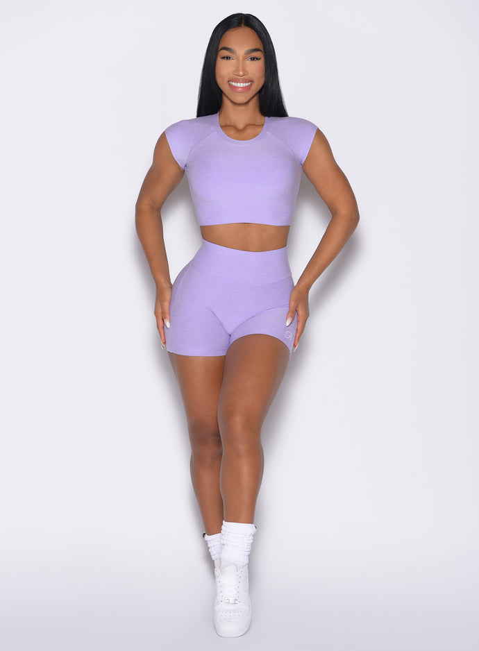 front profile view of a model with both hands on her thighs wearing the Movement Shorts in Sugared Lilac color