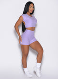 front right side profile view of a model wearing the Movement Shorts in Sugared Lilac color