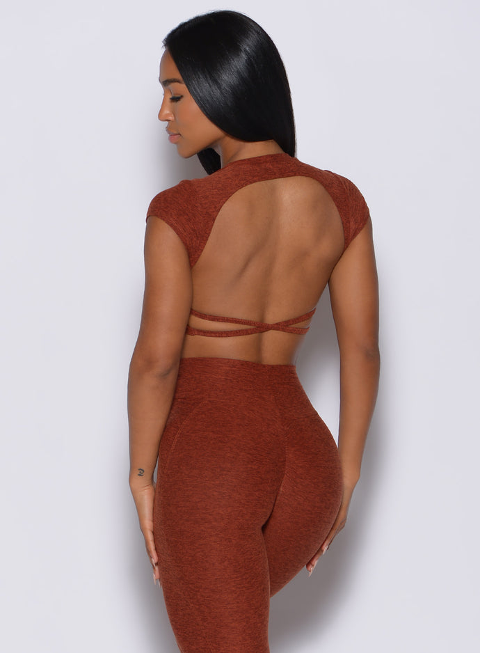 Back profile picture of a beautiful model in our open back tee in Cinnamon color and a matching leggings