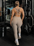 back profile view of a model wearing our curves leggings in nori color along with the matching bra