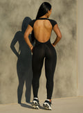 back view of model wearing the open back tee bodysuit in black