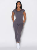 model facing forward wearing wearing our open back tee bodysuit in gray smoke color