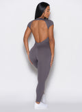 back profile view of a model wearing our Open Back Tee Bodysuit in gray smoke color