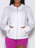 front profile view of a model wearing our white oversized hoodie, along with shorts in berry color