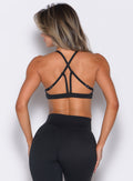 back profile view of a model wearing the Passion Sports Bra in black color