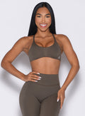 front profile view of a model with one hand on her waist and other hand resting on her thigh wearing the Passion Sports Bra in winter oak color