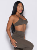 front right side profile view of a model wearing the Passion Sports Bra in winter oak color paired with the matching leggings