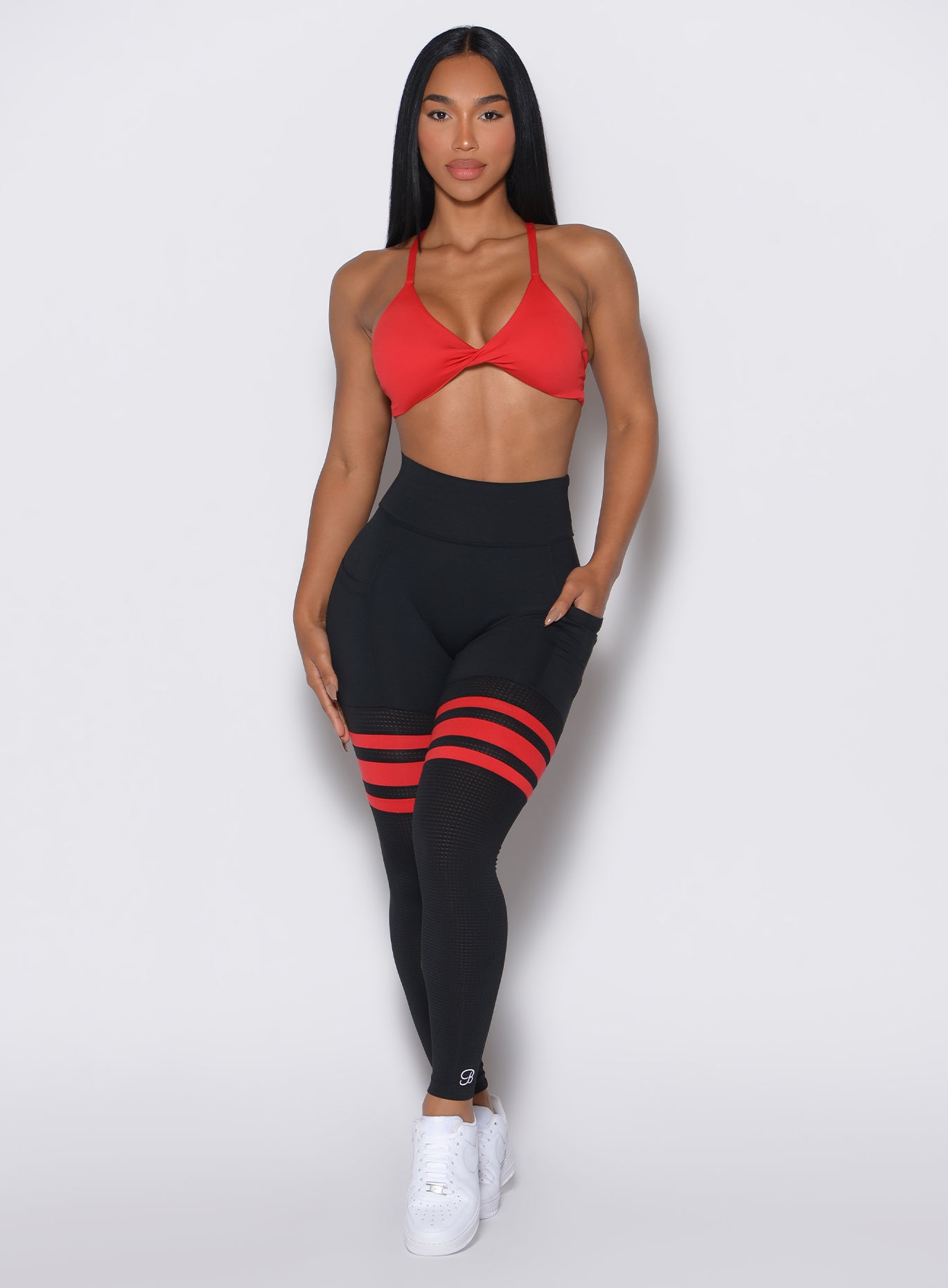 Front profile view of a model wearing the Perform Thigh Highs in Black Fire color along with a matching bra